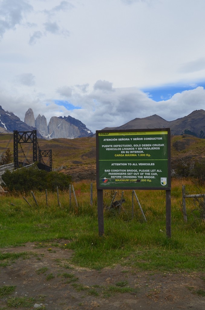 Sign next to Torres del Paine Bridge, indicating 1500Kg load limit and that everyone should get out of the car.